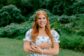 Chloe Welch standing outdoors in a floral dress, representing Clover Garden School as the DAR Good Citizen.