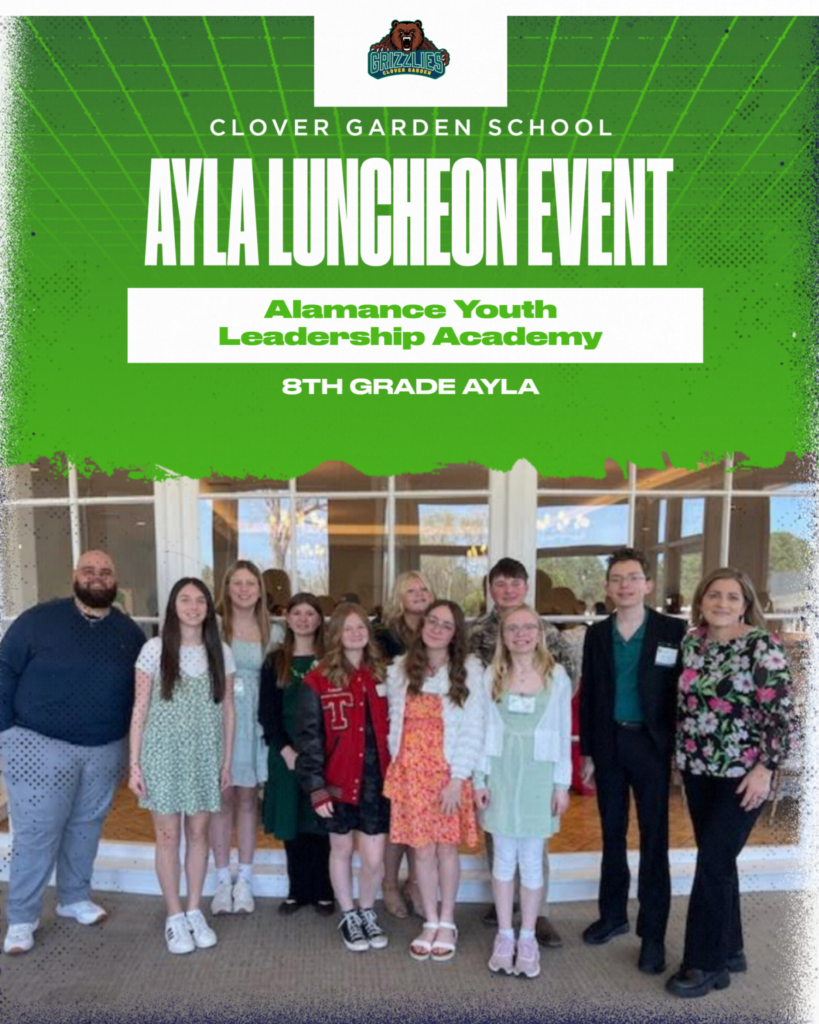A group of Clover Garden School 8th grade students and staff stand together at the AYLA Luncheon Event for the Alamance Youth Leadership Academy, posing indoors in front of large windows at the Alamance Country Club.