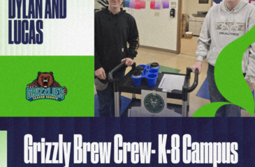 Two students stand indoors at the K–8 campus beside a rolling cart holding drinks and supplies, smiling as they help with the “Grizzly Brew Crew.” The graphic includes Clover Garden Grizzlies branding and reads “Shout out to Dylan and Lucas” and “Grizzly Brew Crew – K–8 Campus.”