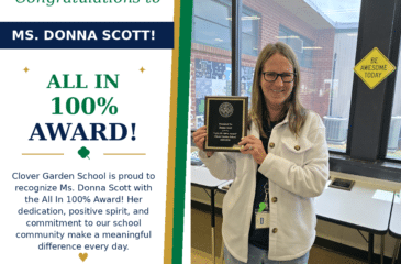 Ms. Donna Scott smiles while holding her CGS All In 100% Award.
