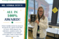Ms. Donna Scott smiles while holding her CGS All In 100% Award.