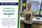 Mrs. Julia Lassiter smiles while holding her CGS Fierce and Fearless Award.