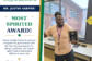 Mr. Justin Harper smiles while holding his CGS Most Spirited Award.