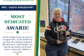 Mrs. Sarah Barlekamp smiles while holding her CGS Most Dedicated Award.