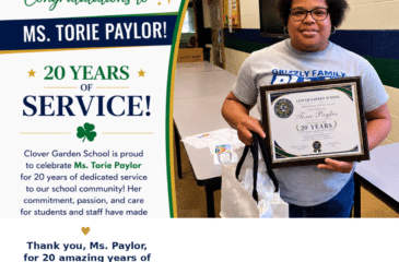 Ms. Torie Paylor smiles while holding her CGS 20 Years of Service recognition award.