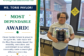 Ms. Torie Paylor smiles while holding her CGS Most Dependable Award.