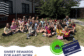 Group of 3rd grade students sitting outside on the grass at school under the heading “Sweet Success in 3rd Grade,” celebrating a multiplication ice cream party for scoring 80 percent or higher on all 10 fact fluency tests, with Clover Garden School branding.